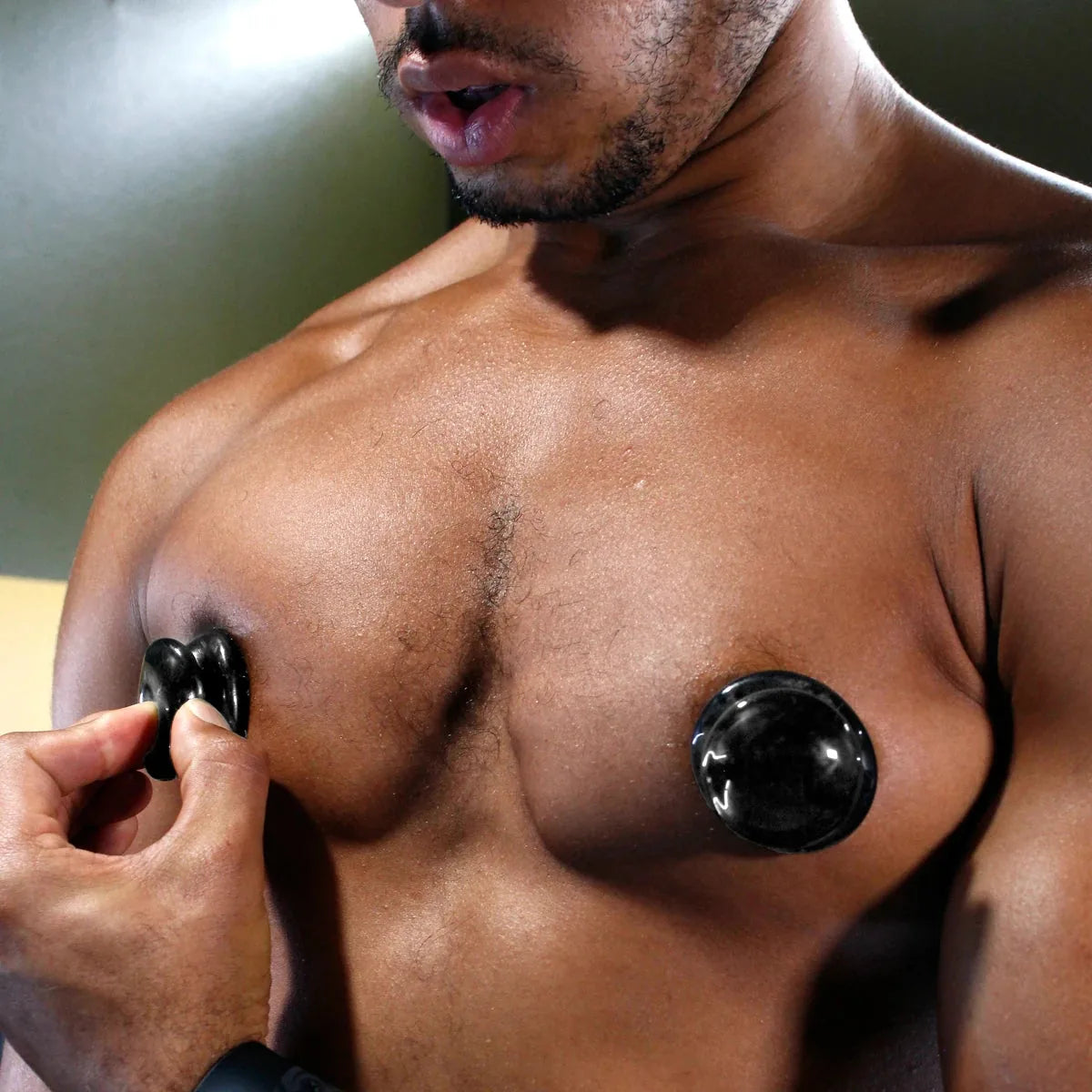 Nip Suckers 3.0 suction cup pinched onto one nipple beside a locked-on cup, Fort Troff
