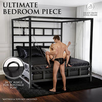 Model holding his partner in a sling hung from the canopy, 24 D-rings callout, King Size Bondage Bed, Fort Troff
