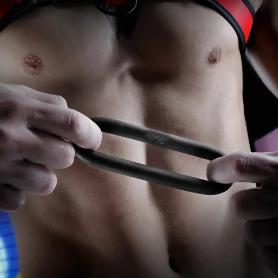 Cush Ring ultra-soft silicone cock ring stretched between fingers to show flex, Fort Troff
