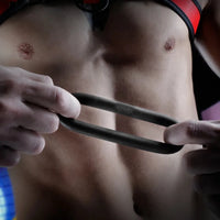 Cush Ring ultra-soft silicone cock ring stretched between fingers to show flex, Fort Troff