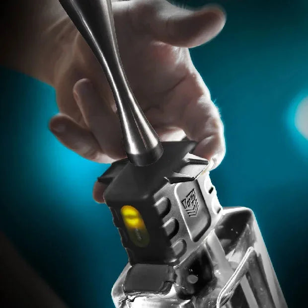 Depth Charge one-touch anal douche close-up of thumb pressing the single power button, Fort Troff
