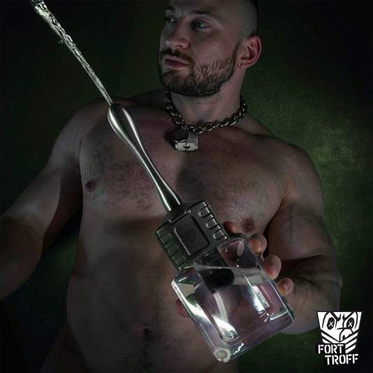 Muscled model holding the Depth Charge One-Touch Anal Douche as water sprays from the steel nozzle, Fort Troff