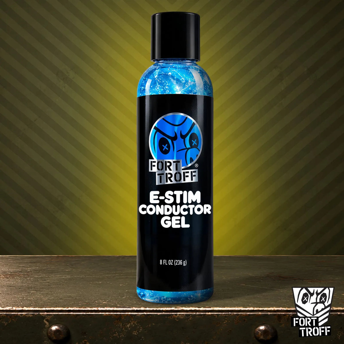 E-Stim Conductor Gel 8 fl oz bottle with electric blue gel on a metal crate, Fort Troff
