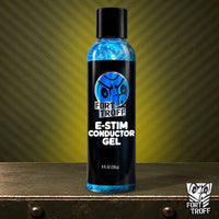 E-Stim Conductor Gel 8 fl oz bottle with electric blue gel on a metal crate, Fort Troff