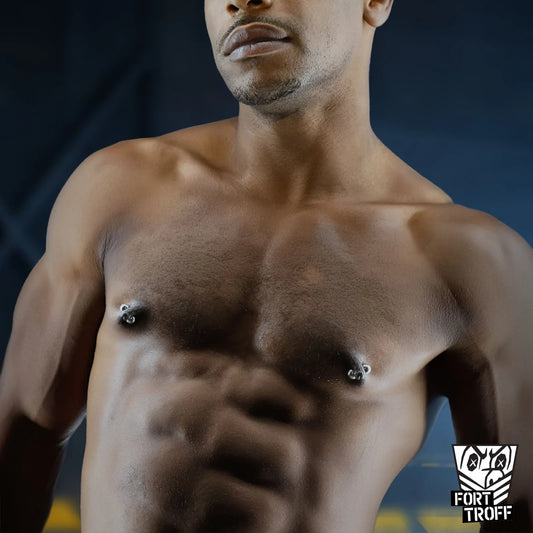 Magno Nip Tuggers magnetic orbs on both nipples of a shirtless model, pierced look, Fort Troff