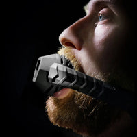 Max Comfort silicone ball gag in a bearded model's mouth, side profile of the bite, Fort Troff