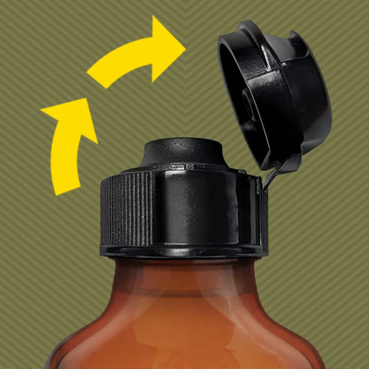 Pig Snout Flip lid snapping open one-handed on an amber essential oil bottle, Fort Troff