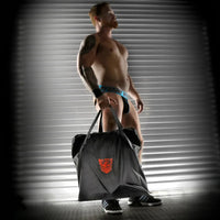 Rimmer Bag ballistic nylon carry bag held by a model in a jockstrap, Fort Troff logo on the side