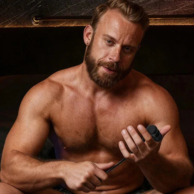 Sounding Hammer urethral sounding kit held by a bearded shirtless model, Fort Troff