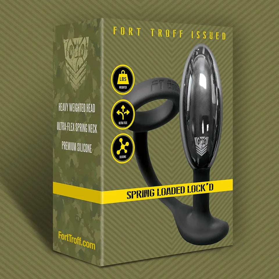 Spring Loaded Lock'D locking metal butt plug beside its Fort Troff Issued camo box