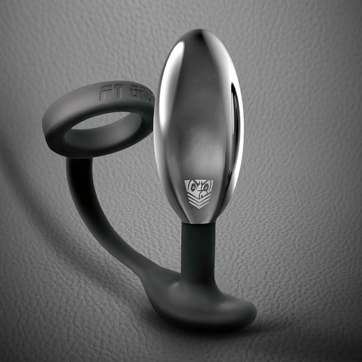 Side view of the Spring Loaded Lock'D metal plug and silicone cock ring