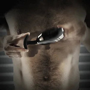 Spring Loaded metal butt plug shown in hand for scale. Fort Troff.