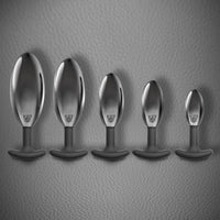 Spring Loaded metal butt plug full size range lined up from XXL to small, Fort Troff
