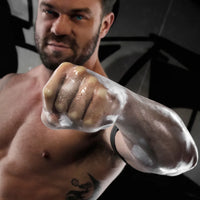 FFister XL Peek-A-Boo Clear fisting glove on a fist pushed toward the camera, Fort Troff