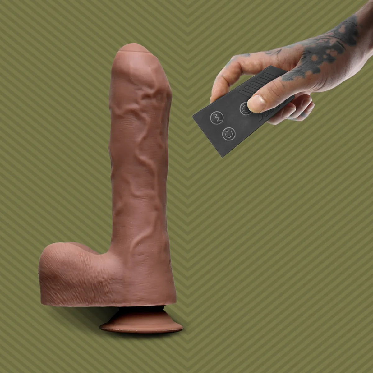 Hand holding the wireless remote next to the Uncut Thruster dildo