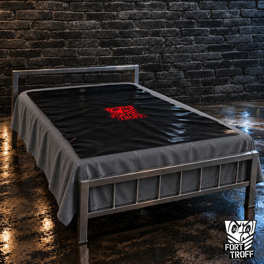Waterproof PVC Playsheet in black with red logo spread over a bed on a steel frame, Fort Troff