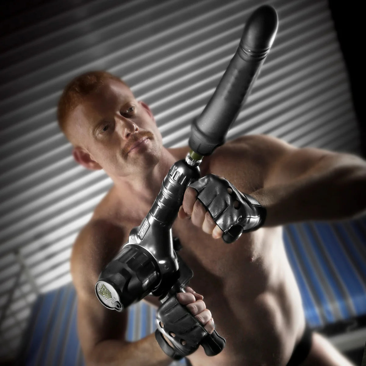 Gunner System handheld mode, model gripping the machine with dildo attached, Fort Troff