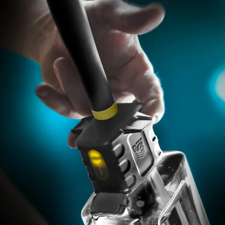 Close-up of a hand gripping the Hydro-Pro control head with the charge indicator lit, Fort Troff
