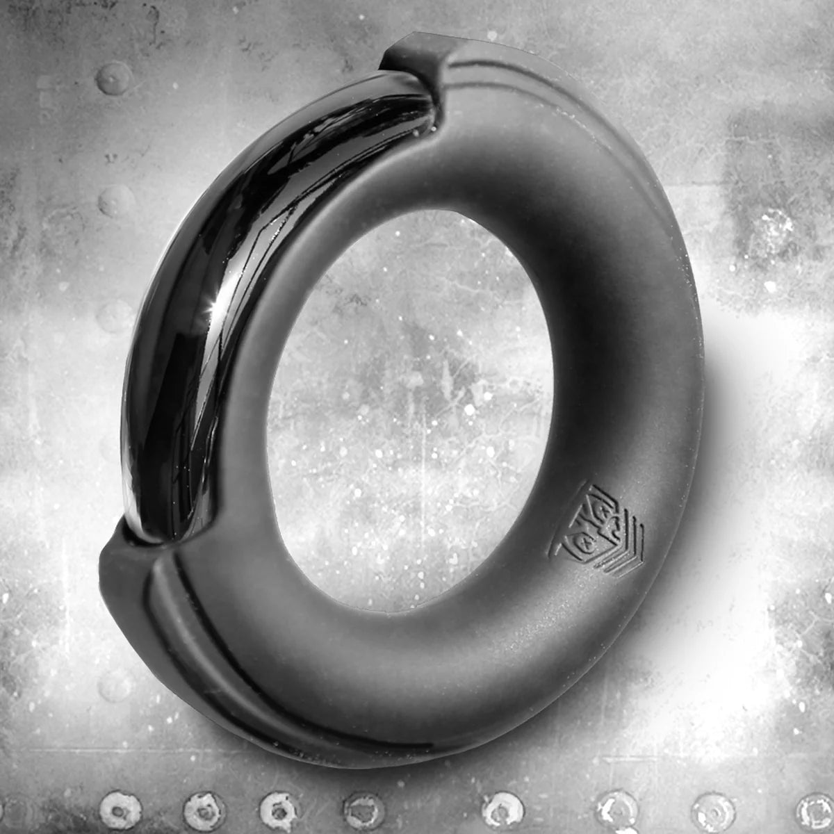 Pinch Zero Ring silicone-cased chrome cock ring hero shot on a riveted steel background, Fort Troff