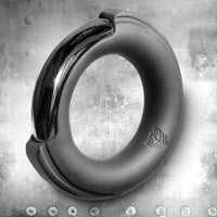 Pinch Zero Ring silicone-cased chrome cock ring hero shot on a riveted steel background, Fort Troff