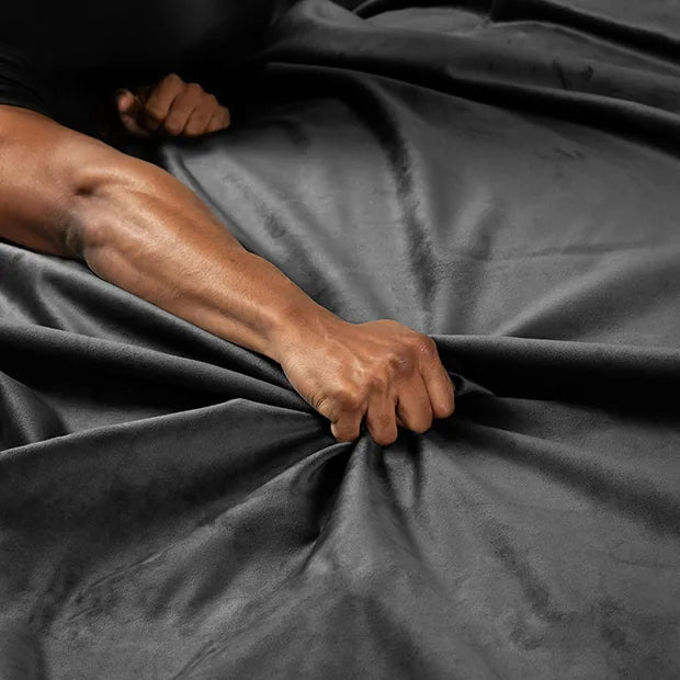 Hand gripping the soft velvet microfiber of the Velvet Guard sheet, Fort Troff