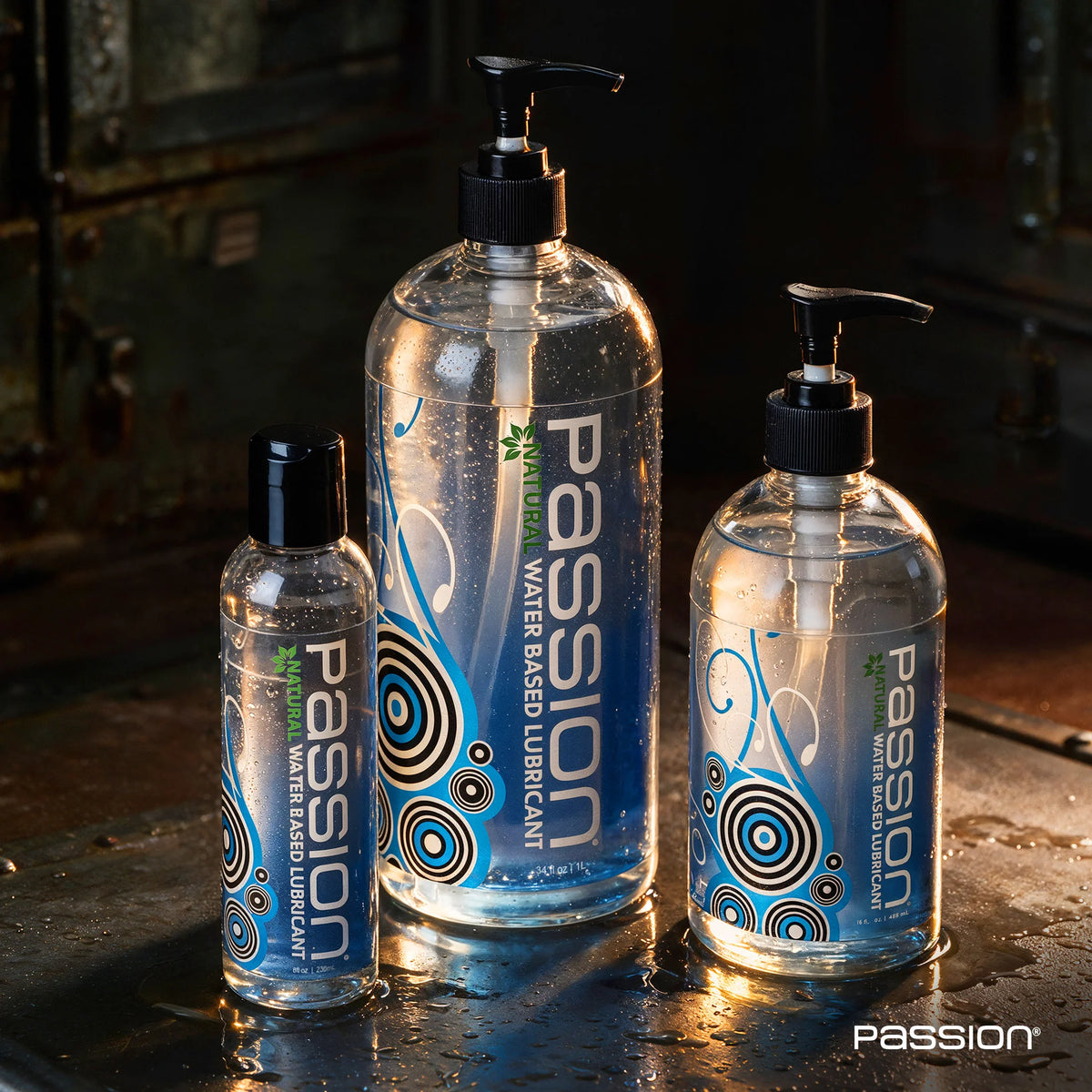Passion Natural water-based lube in 8 oz, 16 oz and 34 oz pump bottles lined up by size, Fort Troff