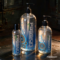 Passion Natural water-based lube in 8 oz, 16 oz and 34 oz pump bottles lined up by size, Fort Troff